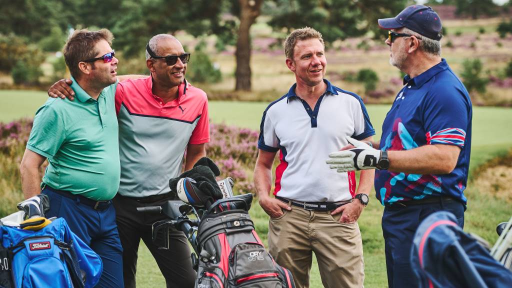 Golfer and caddie discussing strategy on a green