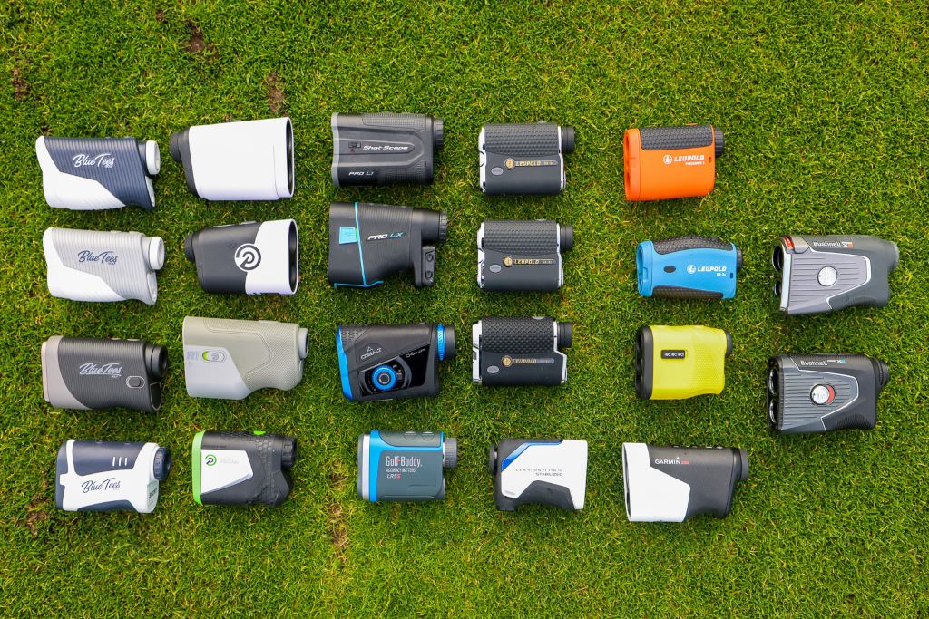 Golfer using laser rangefinder to calculate yardage before a swing on green.