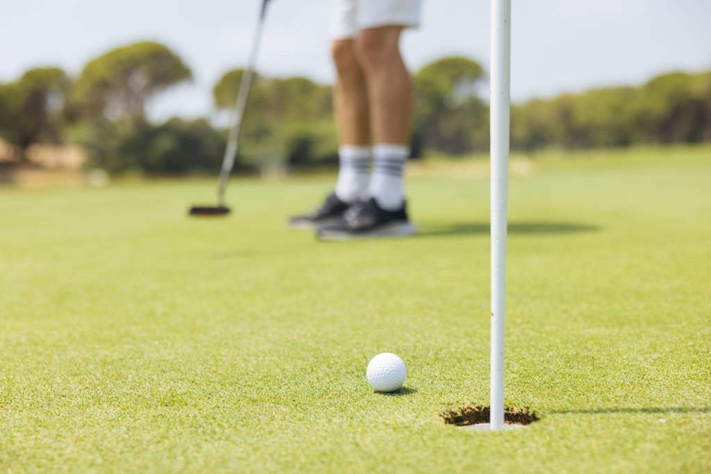 Golf player making a successful stroke