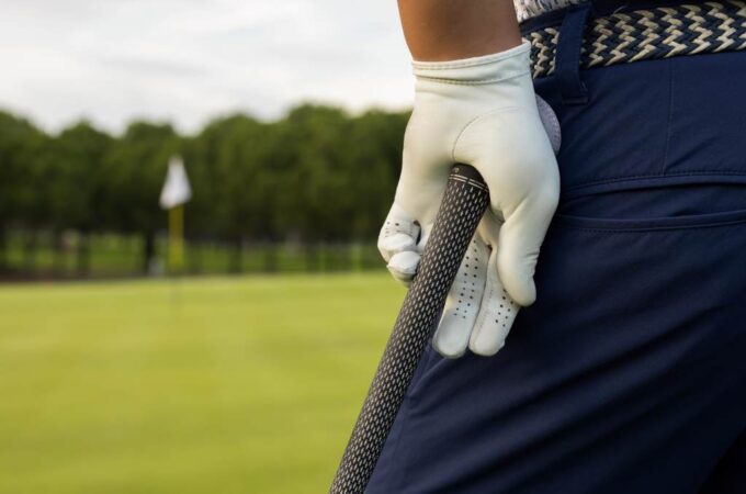 Golfer holding oversize golf grip with relaxed hands