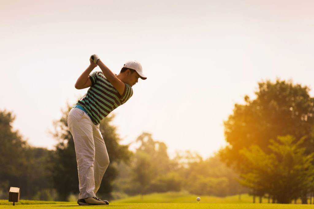 Golfer using Callaway driver on tee box during sunny round