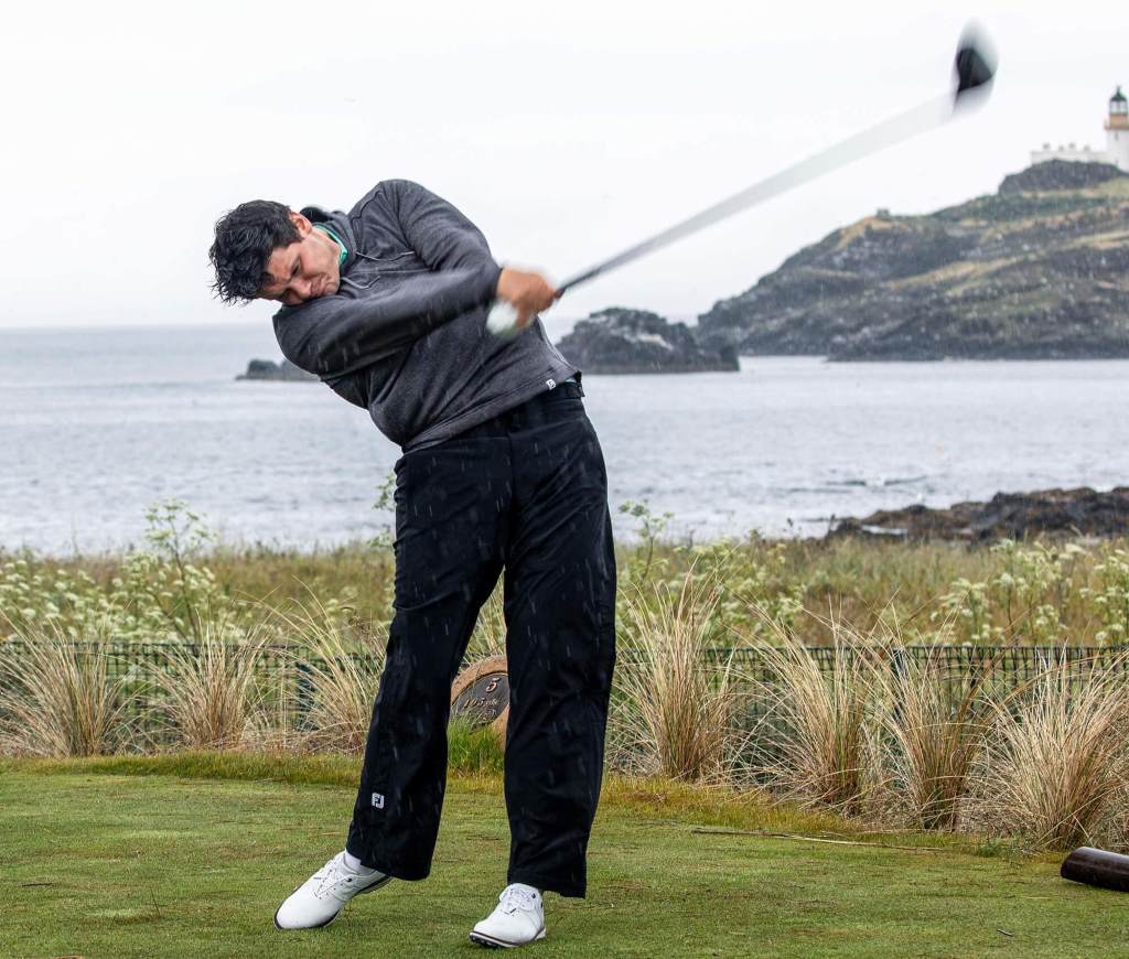 Golfer wearing waterproof rain pants on a wet golf course
