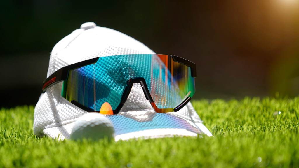 White golf hat and sunglasses on the golf course