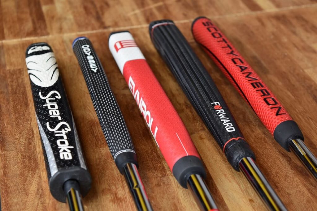 Golfer holding a club with fresh grip for improved swing feel and stability.