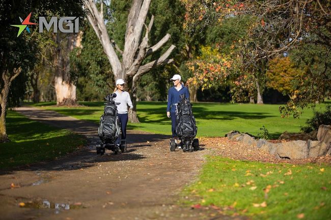MGI Zip Navigator electric golf cart carrying a golf bag across hilly terrain